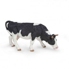Figurine vache noire et blanche broutant